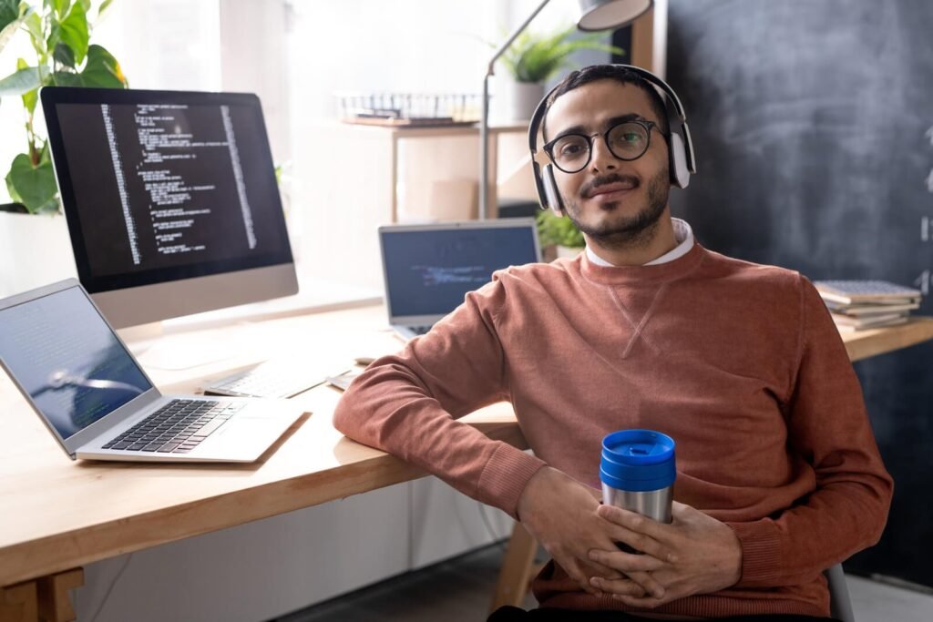 handsome programmer in headphones listening to mus 2023 11 27 04 56 48 utc