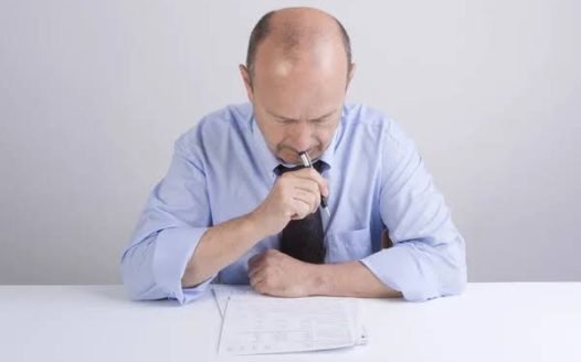 hombre preocupado mirando documento